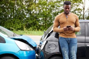 Lexington Car Accident Lawyer - A man standing besides his car crash