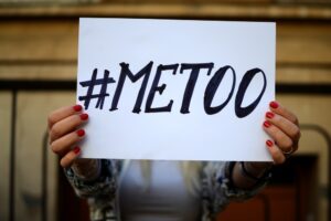 woman holds me too protest sign