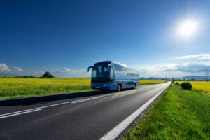 blue-bus-driving-on-asphalt-road