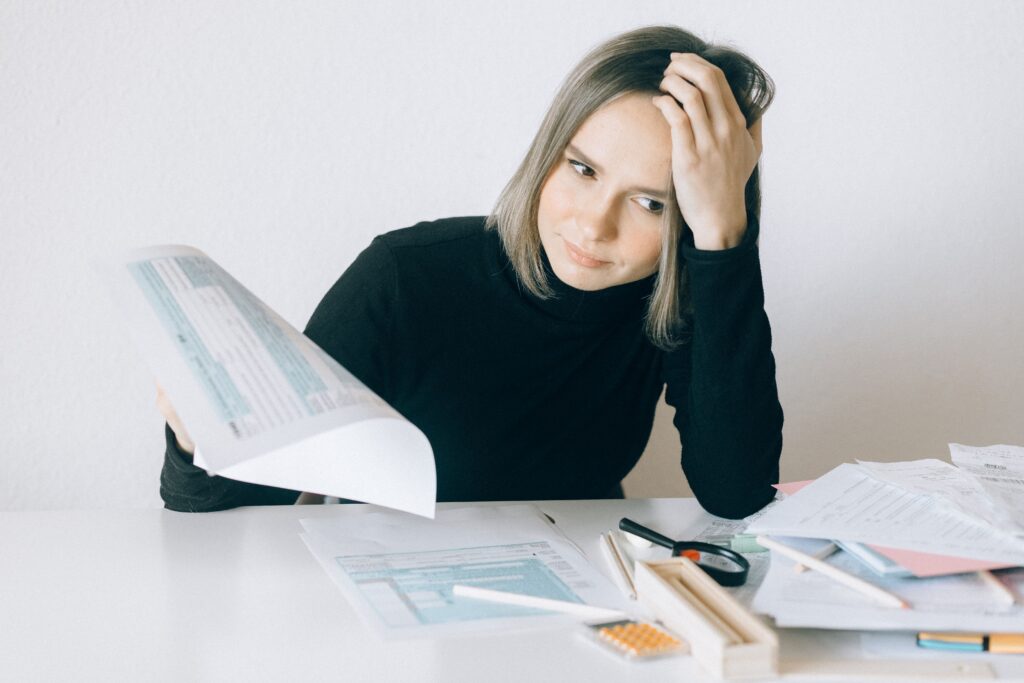 A woman reviews several documents