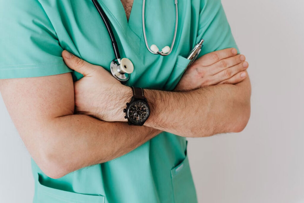 Physician wearing a stethoscope before conducting a medical exam