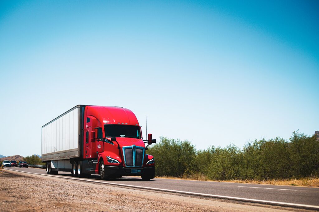 A semi-truck traveling on the road