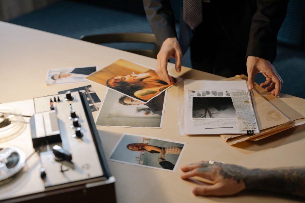 Evidence markers, photographs, and documents arranged on a table