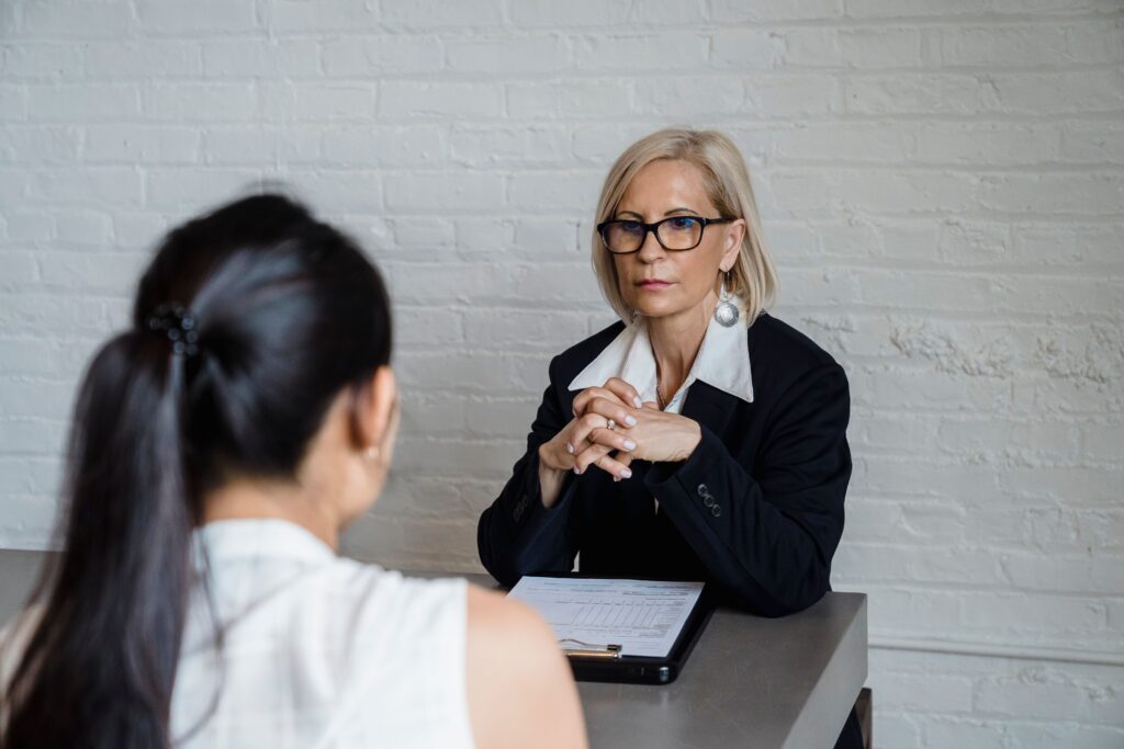 A woman sitting with her hands together during a conversation