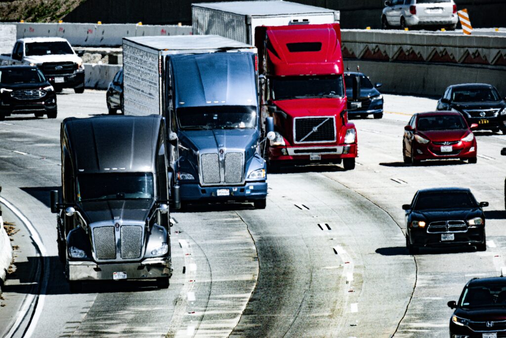 Trucks and passenger vehicles traveling on a busy highway